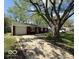 Charming single-story brick home featuring an attached garage and spacious driveway at 4456 N Kenyon Dr, Indianapolis, IN 46226
