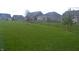Fully fenced backyard with lush lawn, perfect for outdoor activities and pets at 4518 W Meadows Ln, New Palestine, IN 46163
