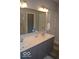 Bathroom featuring double vanity sinks, a large mirror, and a neutral color scheme, offering a clean, modern space at 4518 W Meadows Ln, New Palestine, IN 46163