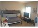 bedroom with a bunk bed, study area, and a window, offering a functional and comfortable space at 4518 W Meadows Ln, New Palestine, IN 46163