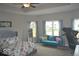 Bedroom featuring a comfortable bed, bright windows, and a sitting area, offering a relaxing and inviting space at 4518 W Meadows Ln, New Palestine, IN 46163