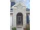 Charming front door with stone archway and covered entryway, offering a warm welcome to guests at 4518 W Meadows Ln, New Palestine, IN 46163