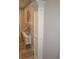 Hallway featuring decorative millwork accents and a console table with lamps and floral arrangements at 4518 W Meadows Ln, New Palestine, IN 46163