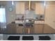 Stylish kitchen featuring a spacious island, stainless steel appliances, and white cabinets at 4518 W Meadows Ln, New Palestine, IN 46163