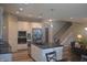 Modern kitchen with stainless steel appliances, a center island with seating, and an open layout to the living area at 4518 W Meadows Ln, New Palestine, IN 46163