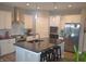 Modern kitchen with a large island, stainless steel appliances, and sleek white cabinetry at 4518 W Meadows Ln, New Palestine, IN 46163