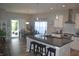 Open concept kitchen with an island, modern appliances, and a view to the dining area and outdoor patio at 4518 W Meadows Ln, New Palestine, IN 46163