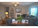 Bright living room featuring a cozy fireplace, plush seating, and decor, creating a warm and welcoming atmosphere at 4518 W Meadows Ln, New Palestine, IN 46163