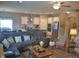 Open concept living room with comfortable seating and stylish decor, leading to the kitchen at 4518 W Meadows Ln, New Palestine, IN 46163