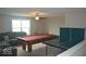 Spacious living room featuring a pool table, ping pong table, and comfortable seating area, perfect for entertaining at 4518 W Meadows Ln, New Palestine, IN 46163