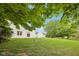 A view of a home's manicured backyard and exterior from under a tree at 5 Statesman Ct, Brownsburg, IN 46112