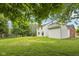 Expansive backyard featuring a lush lawn and mature trees surrounding a two-story home at 5 Statesman Ct, Brownsburg, IN 46112
