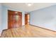 Bright bedroom with wood floor, closet, and fresh blue paint at 5 Statesman Ct, Brownsburg, IN 46112