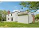 View of the home's rear exterior, displaying a well-maintained lawn and the home's architectural details at 5 Statesman Ct, Brownsburg, IN 46112