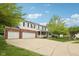 Charming two-story home with brick accents, white siding, covered porch, a three car garage and a wide driveway at 5 Statesman Ct, Brownsburg, IN 46112