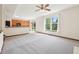 Bright living room with large windows, and ceiling fan that flows into the kitchen at 5 Statesman Ct, Brownsburg, IN 46112