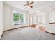 Bright living room with neutral carpet, ceiling fan, and large windows that provide beautiful views at 5 Statesman Ct, Brownsburg, IN 46112
