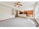 Large living room flows into kitchen, featuring neutral carpet and lots of natural light from the windows at 5 Statesman Ct, Brownsburg, IN 46112