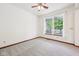 Clean living room boasting neutral carpet, ceiling fan, and abundant natural light through large windows at 5 Statesman Ct, Brownsburg, IN 46112