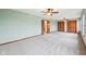 Expansive main bedroom with neutral carpet, ceiling fans, and closets at 5 Statesman Ct, Brownsburg, IN 46112
