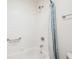 Bright, clean shower/tub combo with white tile and blue accent curtain at 5 Statesman Ct, Brownsburg, IN 46112