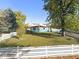 Charming single-story home with a well-maintained front yard and white picket fence at 5142 W Southern Ave, Indianapolis, IN 46241