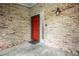 Cozy front porch with brick siding, a red front door, a decorative lantern, and a welcome mat at 5204 Whipple Wood Ct, Indianapolis, IN 46226