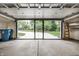 A clean garage with a large windowed garage door and built-in shelving provides ample parking and storage at 5204 Whipple Wood Ct, Indianapolis, IN 46226