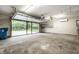 A clean garage with a large windowed garage door and built-in shelving provides ample parking and storage at 5204 Whipple Wood Ct, Indianapolis, IN 46226