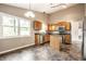 Well-lit kitchen with vinyl flooring, an island, stainless steel appliances, and an open layout at 5204 Whipple Wood Ct, Indianapolis, IN 46226