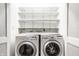 Convenient laundry room with washer, dryer, and white shelving at 5204 Whipple Wood Ct, Indianapolis, IN 46226