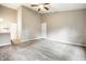Open-concept living room with ceiling fan, neutral walls, and carpet flooring at 5204 Whipple Wood Ct, Indianapolis, IN 46226
