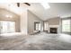 Spacious living room featuring vaulted ceilings, a fireplace, a skylight, and a neutral color scheme at 5204 Whipple Wood Ct, Indianapolis, IN 46226
