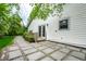 Home exterior showcasing a patio area with stone pavers, a sliding glass door, and green landscaping at 5204 Whipple Wood Ct, Indianapolis, IN 46226