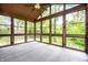 Bright sunroom with large windows offering great views, a ceiling fan, and comfortable flooring at 5204 Whipple Wood Ct, Indianapolis, IN 46226