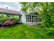 Backyard view of sunroom with paver walkway and lush landscaping surrounding at 5204 Whipple Wood Ct, Indianapolis, IN 46226