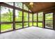 Bright sunroom with large windows offering great views, a ceiling fan, and comfortable flooring at 5204 Whipple Wood Ct, Indianapolis, IN 46226