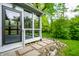 Bright sunroom featuring many windows and a stone paver walkway surrounded by lush landscaping at 5204 Whipple Wood Ct, Indianapolis, IN 46226