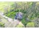House nestled among trees features a gravel driveway, play set, and plenty of green space at 5386 W 1100 N, Fountaintown, IN 46130