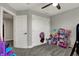 Spacious bedroom with closet doors, carpeted floors, and play furniture at 5386 W 1100 N, Fountaintown, IN 46130