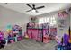Bright bedroom with carpeted floor, lots of toys and a ceiling fan at 5386 W 1100 N, Fountaintown, IN 46130