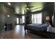 Spacious bedroom with vaulted ceilings, dark grey walls, dark wood-look floors, and bright natural lighting at 5386 W 1100 N, Fountaintown, IN 46130