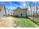 Side yard showing a modern farmhouse with a black chain-link fence and yard with grass and dirt at 5386 W 1100 N, Fountaintown, IN 46130