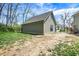 Side exterior view showing a modern farmhouse with a black chain-link fence and yard with grass and dirt at 5386 W 1100 N, Fountaintown, IN 46130