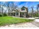 Charming exterior elevation of the home featuring a large porch and lush green lawn at 5386 W 1100 N, Fountaintown, IN 46130
