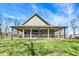 Exterior view of a charming home with a wraparound porch overlooking a lush green lawn at 5386 W 1100 N, Fountaintown, IN 46130