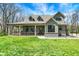 Charming home featuring a welcoming porch, dormer windows, and a well-manicured lawn at 5386 W 1100 N, Fountaintown, IN 46130