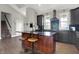 Open kitchen featuring dark cabinetry, a large island with seating, and modern finishes at 5386 W 1100 N, Fountaintown, IN 46130