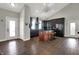 Bright, open kitchen with modern appliances, a center island, and hardwood flooring at 5386 W 1100 N, Fountaintown, IN 46130