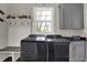 Modern laundry room with overhead cabinets, laundry sink, and newer appliances with great shelf space at 5386 W 1100 N, Fountaintown, IN 46130